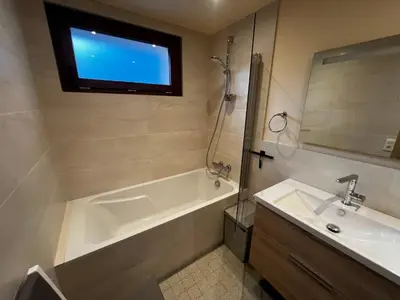 a bathroom with a tub and a sink and a window at Vue du Mont-Blanc in Passy