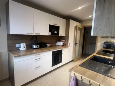 a kitchen with white cabinets and a sink at Vue du Mont-Blanc in Passy