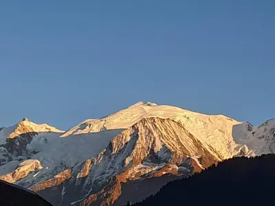 a snow covered mountain with a blue sky in the background at Vue du Mont-Blanc in Passy