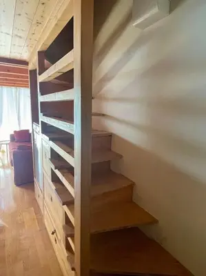 a wooden staircase in a room with a wall at Duplex 4 pers vue MontBlanc , Grands Montets in Chamonix-Mont-Blanc