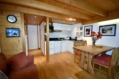 a kitchen and dining room with a table and chairs at Duplex 4 pers vue MontBlanc , Grands Montets in Chamonix-Mont-Blanc