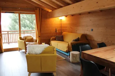 a living room with a couch and chairs in a cabin at Appartement de standing Chalet Bostan in Samoëns