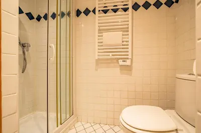 a bathroom with a toilet and a glass shower at Alpine Garden - Truly hidden gem with sunny garden in Chamonix town center in Chamonix-Mont-Blanc