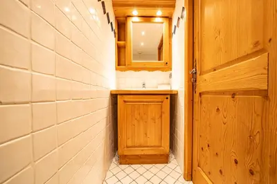 a small bathroom with a sink and a mirror at Alpine Garden - Truly hidden gem with sunny garden in Chamonix town center in Chamonix-Mont-Blanc