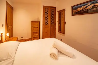 a bedroom with a bed with a towel on it at Alpine Garden - Truly hidden gem with sunny garden in Chamonix town center in Chamonix-Mont-Blanc