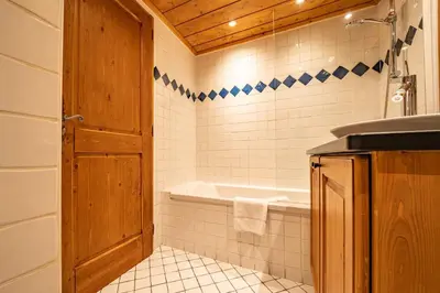 a bathroom with a bath tub and a sink at Alpine Garden - Truly hidden gem with sunny garden in Chamonix town center in Chamonix-Mont-Blanc
