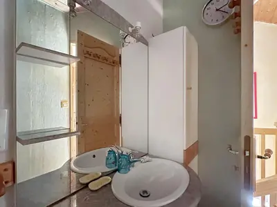 a bathroom with a white sink and a mirror at ob219 4 pieces duplex 6 personnes proche pistes in Les Carroz d'Araches