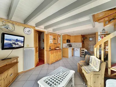 a living room with a tv and a kitchen at ob219 4 pieces duplex 6 personnes proche pistes in Les Carroz d'Araches