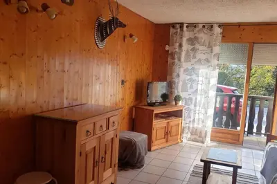 a room with a bed and a tv on a wall at Chaleureux refuge thermal in Saint-Gervais-les-Bains