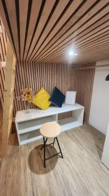a room with a chair and a shelf with pillows at Cocon Face au MontBlanc in Sallanches