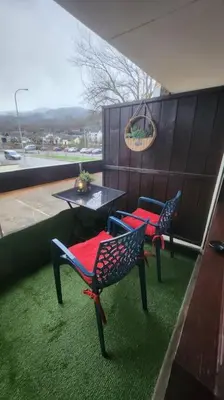 a patio with two chairs and a table on a building at Cocon Face au MontBlanc in Sallanches