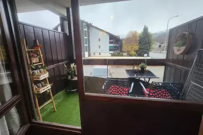 a view of a balcony with a table on a patio at Cocon Face au MontBlanc in Sallanches
