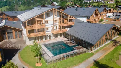 an aerial view of a large house with a swimming pool at Exclusive accommodation terrace, parking and pool in Megève