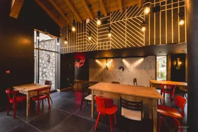 a dining room with tables and red chairs at Exclusive accommodation terrace, parking and pool in Megève