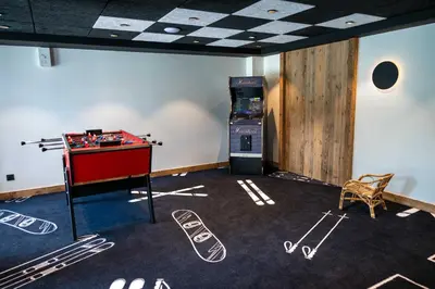 a room with a foosball table and a game console at Exclusive accommodation terrace, parking and pool in Megève