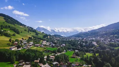 a small town in a valley in the mountains at Exclusive accommodation terrace, parking and pool in Megève