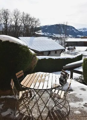 a picnic table and bench in the snow at Chez Colette - Appartement à la montagne in Demi-Quartier