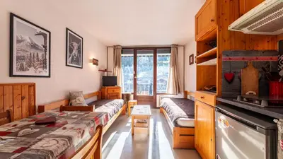 a room with a bed and a couch and a tv at Grand Morillon 212 - 2P5 in Morillon