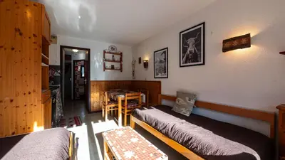 a room with two beds and a table in it at Grand Morillon 212 - 2P5 in Morillon