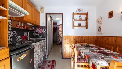 a dining room with a table and a kitchen at Grand Morillon 212 - 2P5 in Morillon