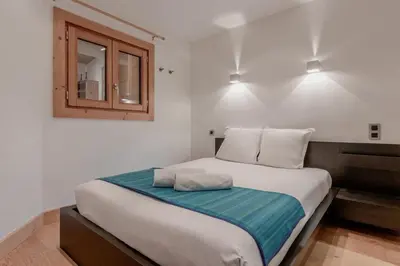 a bedroom with a large bed with two pillows on it at La Cremaillere in Sallanches