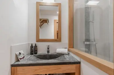 a bathroom with a sink and a mirror at La Cremaillere in Sallanches