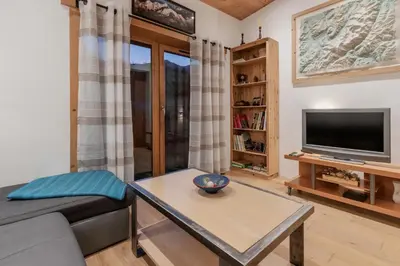 a living room with a couch and a tv at La Cremaillere in Sallanches