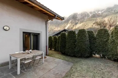 a living room with a table and a couch at Jardin du Brevent in Chamonix-Mont-Blanc