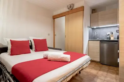 a bedroom with a large bed with red pillows at Jardin du Mont Blanc in Chamonix-Mont-Blanc