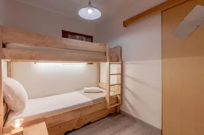 a small room with two bunk beds in it at Jardin du Mont Blanc in Chamonix-Mont-Blanc