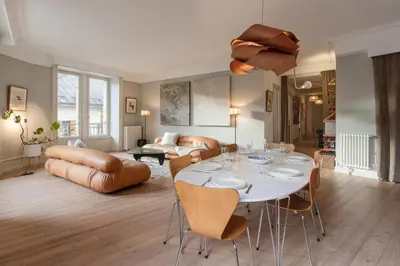 a living room with a table and chairs at Le Metropole - Centre-ville - Spacieux in Chamonix-Mont-Blanc