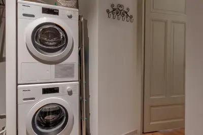 two washing machines and a refrigerator in a room at Le Metropole - Centre-ville - Spacieux in Chamonix-Mont-Blanc