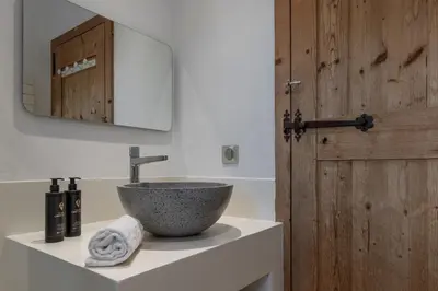 a bathroom with a bowl sink and a mirror at Chalet Des Grands Vanays in Les Houches