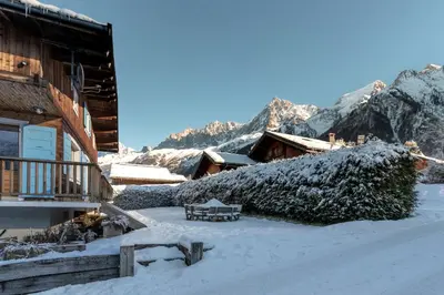 a snow covered yard next to a log cabin at Chalet Des Grands Vanays in Les Houches
