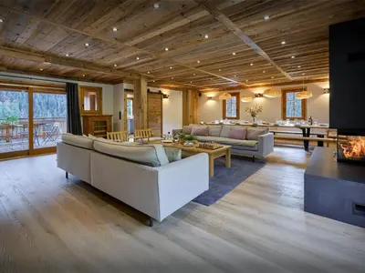 a living room with couches and a fireplace at Chalet Les Pellys - OVO Network in Samoëns