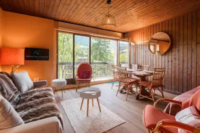 a living room with a couch and a table at Appartement Cornec - Your stay in Megève in Megève