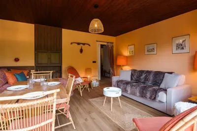 a living room with a couch and a table at Appartement Cornec - Your stay in Megève in Megève