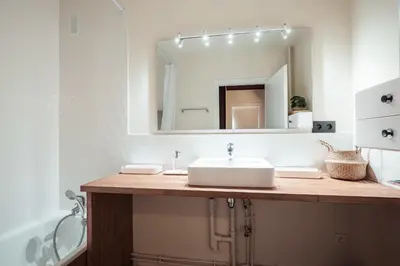 a bathroom with a sink and a mirror at Appartement Cornec - Your stay in Megève in Megève