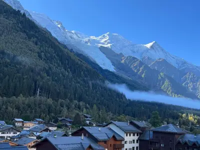 a town in the mountains with snow covered mountains at Chamonix Charmant duplex 4 personnes et un enfant in Chamonix-Mont-Blanc