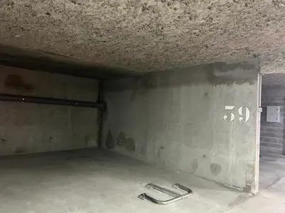 an empty room with a concrete wall and a room with a door at Chamonix Charmant duplex 4 personnes et un enfant in Chamonix-Mont-Blanc
