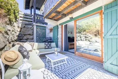 a patio with a couch and a table at Spacieux 6pax 3ch Vue MtBlanc Central Parking in Chamonix-Mont-Blanc