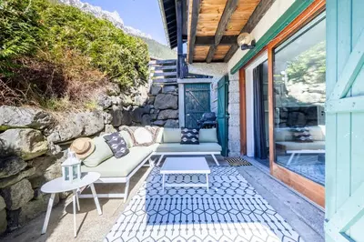 a patio with a couch and a table at Spacieux 6pax 3ch Vue MtBlanc Central Parking in Chamonix-Mont-Blanc