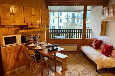 a living room with a table and a couch at City center studio near the slopes in Chamonix-Mont-Blanc