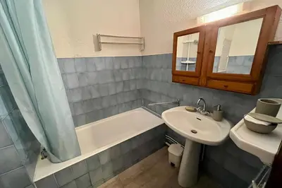 a bathroom with a sink and a bath tub and a sink at City center studio near the slopes in Chamonix-Mont-Blanc