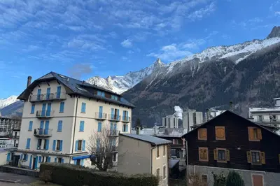 a group of buildings in front of a mountain at City center studio near the slopes in Chamonix-Mont-Blanc
