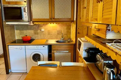a kitchen with a sink and a washing machine at City center studio near the slopes in Chamonix-Mont-Blanc
