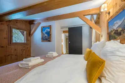a bedroom with a large bed with towels on it at Chalet Altura- 5 Bedrooms - Jacuzzi and Sauna - By Cozee Rentals in Chamonix-Mont-Blanc