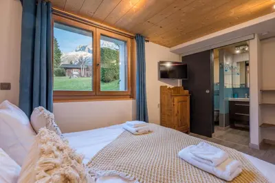 a bedroom with a large bed with towels on it at Chalet Altura- 5 Bedrooms - Jacuzzi and Sauna - By Cozee Rentals in Chamonix-Mont-Blanc