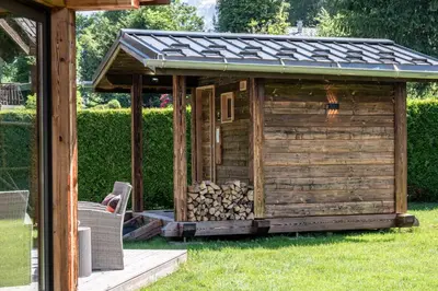 a wooden shed with a roof on top of it at Chalet Altura- 5 Bedrooms - Jacuzzi and Sauna - By Cozee Rentals in Chamonix-Mont-Blanc