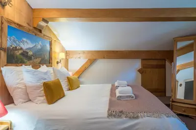 a bedroom with a large white bed in a room at Chalet Altura- 5 Bedrooms - Jacuzzi and Sauna - By Cozee Rentals in Chamonix-Mont-Blanc